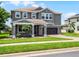 This eye-catching two-story home has a manicured lawn, landscape, and brick driveway at 15900 Citrus Knoll Dr, Winter Garden, FL 34787