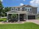 Charming two-story home with a landscaped front yard and inviting covered entrance, perfect for curb appeal at 15900 Citrus Knoll Dr, Winter Garden, FL 34787
