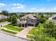 Charming two-story home with an attached two-car garage, manicured lawn, and brick paved driveway at 15900 Citrus Knoll Dr, Winter Garden, FL 34787