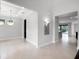 Open concept living area with decorative wall sconce, dining and kitchen access at 15900 Citrus Knoll Dr, Winter Garden, FL 34787