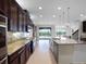 Spacious kitchen featuring granite counters, stainless steel appliances, and an open layout to the living area at 15900 Citrus Knoll Dr, Winter Garden, FL 34787