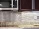 Close-up of the kitchen backsplash, showing a mix of stainless steel and decorative tiles at 15900 Citrus Knoll Dr, Winter Garden, FL 34787
