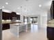 Bright and airy kitchen featuring a large island, stainless steel appliances, and seamless access to the outdoor space at 15900 Citrus Knoll Dr, Winter Garden, FL 34787