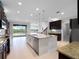 Spacious kitchen with modern appliances, granite countertops, and an open layout to the living area at 15900 Citrus Knoll Dr, Winter Garden, FL 34787