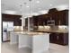 Bright kitchen featuring a large island, modern appliances, and dark wood cabinetry at 15900 Citrus Knoll Dr, Winter Garden, FL 34787