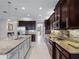 Well-equipped kitchen features ample dark wood cabinetry, stainless steel appliances, and a spacious granite island at 15900 Citrus Knoll Dr, Winter Garden, FL 34787