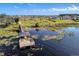 Scenic aerial shot of a community lake with a private dock and stunning views of surrounding homes at 15900 Citrus Knoll Dr, Winter Garden, FL 34787