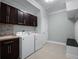 Laundry room featuring a washer and dryer set, tile flooring, and cabinet storage at 15900 Citrus Knoll Dr, Winter Garden, FL 34787