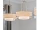 Stylish, neutral, pendant lighting fixtures brighten the dining room at 15900 Citrus Knoll Dr, Winter Garden, FL 34787