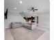 Open-concept living room with neutral tones, tile floors, and an inviting atmosphere with an open kitchen concept at 15900 Citrus Knoll Dr, Winter Garden, FL 34787