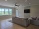 Bright living room featuring neutral colors, tile flooring, a ceiling fan, and a view of the outdoors at 15900 Citrus Knoll Dr, Winter Garden, FL 34787