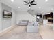 Open concept living room features neutral tones, with a view of kitchen at 15900 Citrus Knoll Dr, Winter Garden, FL 34787