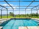 A stunning pool area that includes water features and is enclosed with a screened cage at 15900 Citrus Knoll Dr, Winter Garden, FL 34787
