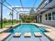 An amazing pool area with water features, stepping stones and a screened cage at 15900 Citrus Knoll Dr, Winter Garden, FL 34787