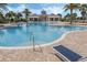 Stunning community pool with comfortable seating, a large pool deck, and beautiful landscaping at 15900 Citrus Knoll Dr, Winter Garden, FL 34787