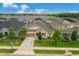 Captivating aerial view of the home surrounded by lush landscaping and a tranquil lake, offering a serene living environment at 1593 Osprey View Dr, Apopka, FL 32703