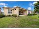 Expansive backyard featuring a covered patio and lush landscaping, ideal for outdoor entertaining and relaxation at 1593 Osprey View Dr, Apopka, FL 32703