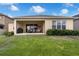 Inviting backyard featuring a covered patio, green grass, and well-maintained landscaping at 1593 Osprey View Dr, Apopka, FL 32703