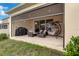 Inviting covered patio features comfortable seating, a hanging swing, and an outdoor grill at 1593 Osprey View Dr, Apopka, FL 32703