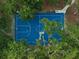 Aerial shot of a blue outdoor basketball court, surrounded by trees, offering a recreational space at 1593 Osprey View Dr, Apopka, FL 32703