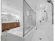 Luxurious bathroom with a soaking tub encased in glass next to a separate standing shower at 1593 Osprey View Dr, Apopka, FL 32703