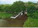 Aerial image of a boat dock in a lake surrounded by trees, offering direct water access at 1593 Osprey View Dr, Apopka, FL 32703