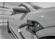 Close up of an EV charging station and car in a modern garage, showing home charging capabilities at 1593 Osprey View Dr, Apopka, FL 32703