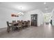 Traditional dining room with an elegant chandelier, large table, and access to the front entryway at 1593 Osprey View Dr, Apopka, FL 32703