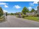 A secure gated community entrance showcases well-maintained landscaping and stone detailing for a welcoming appeal at 1593 Osprey View Dr, Apopka, FL 32703