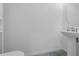 Half bathroom showcasing a pedestal sink with an oval mirror, tiled floor, and neutral wall paint at 1593 Osprey View Dr, Apopka, FL 32703