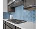 Close-up of kitchen with a stylish backsplash and stainless steel gas stovetop at 1593 Osprey View Dr, Apopka, FL 32703