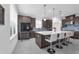 Gourmet kitchen features an island with seating, stainless steel appliances, and sleek modern cabinetry at 1593 Osprey View Dr, Apopka, FL 32703