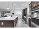 Spacious kitchen featuring a large island, stainless steel appliances, and views of the outdoor living area at 1593 Osprey View Dr, Apopka, FL 32703