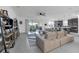 Open-concept living room boasts stylish sectional sofa, ceiling fan, and sliding glass doors to outdoor living at 1593 Osprey View Dr, Apopka, FL 32703