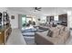 Open-concept living room with tile floors, comfortable sectional seating, and sliding glass doors to the outdoor patio at 1593 Osprey View Dr, Apopka, FL 32703