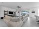 Expansive living room with modern furnishings, a large TV, and access to an outdoor space via sliding glass doors at 1593 Osprey View Dr, Apopka, FL 32703