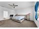 Spacious carpeted main bedroom with a ceiling fan, window, desk and ensuite bathroom access at 1593 Osprey View Dr, Apopka, FL 32703