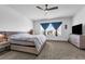 Bright main bedroom with carpeted floors, a ceiling fan, dresser, and a large window with curtains at 1593 Osprey View Dr, Apopka, FL 32703