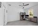 Well-lit home office featuring a ceiling fan, a window, a spacious desk and neutral toned color scheme at 1593 Osprey View Dr, Apopka, FL 32703
