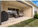 Relaxing covered patio with comfortable seating and sliding glass doors for seamless indoor-outdoor living at 1593 Osprey View Dr, Apopka, FL 32703
