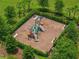 Overhead view of a fenced playground with benches, featuring modern play equipment and mulch ground cover at 1593 Osprey View Dr, Apopka, FL 32703