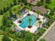 Aerial image of a beautiful community pool area surrounded by lush palm trees and plenty of lounge chairs at 1593 Osprey View Dr, Apopka, FL 32703