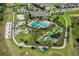 Overhead view of a community offering a pool, mini-golf, and beach volleyball, all amidst lush landscaping at 17996 Adrift Rd, Winter Garden, FL 34787