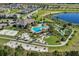 An aerial view of community amenities including a pool, sand volleyball court, and mini-golf course surrounded by natural beauty at 17996 Adrift Rd, Winter Garden, FL 34787