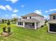 A backyard with well-maintained lawn and a covered patio at 17996 Adrift Rd, Winter Garden, FL 34787