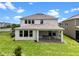 A spacious backyard with well-maintained lawn and covered patio at 17996 Adrift Rd, Winter Garden, FL 34787