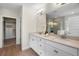 Modern bathroom boasts double sinks, sleek white cabinetry, and a large mirror at 17996 Adrift Rd, Winter Garden, FL 34787