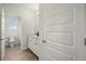 Bright bathroom featuring white cabinets and a wood-look tile flooring at 17996 Adrift Rd, Winter Garden, FL 34787