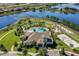 Aerial view showcasing an array of community amenities: a pool, mini-golf, volleyball, all set by a serene lake at 17996 Adrift Rd, Winter Garden, FL 34787