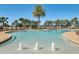 Bright and inviting community pool area with palm trees, fountains, and plenty of lounge chairs for relaxing at 17996 Adrift Rd, Winter Garden, FL 34787